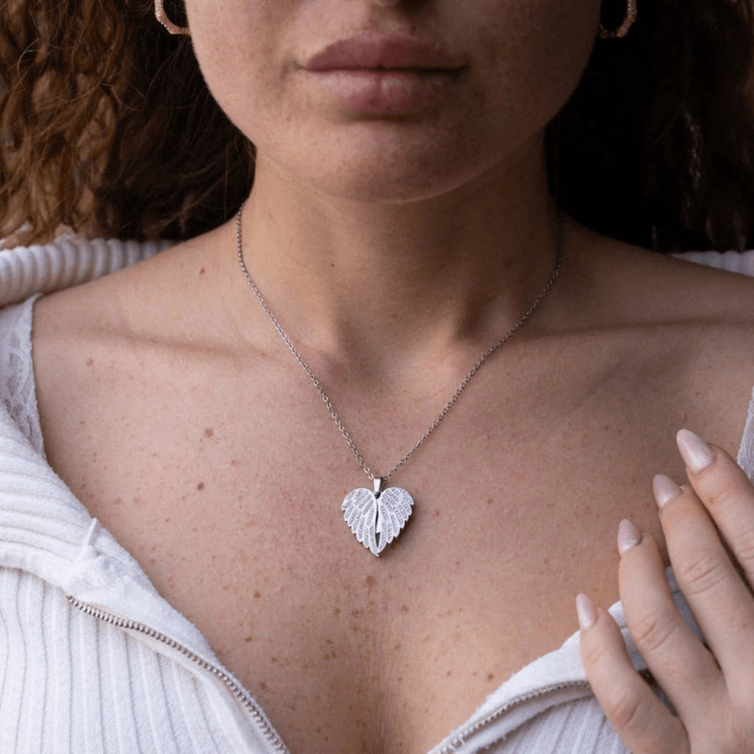 Girl wearing Eternal Embrace silver heart-shaped necklace on chain, symbolizing love and protection.