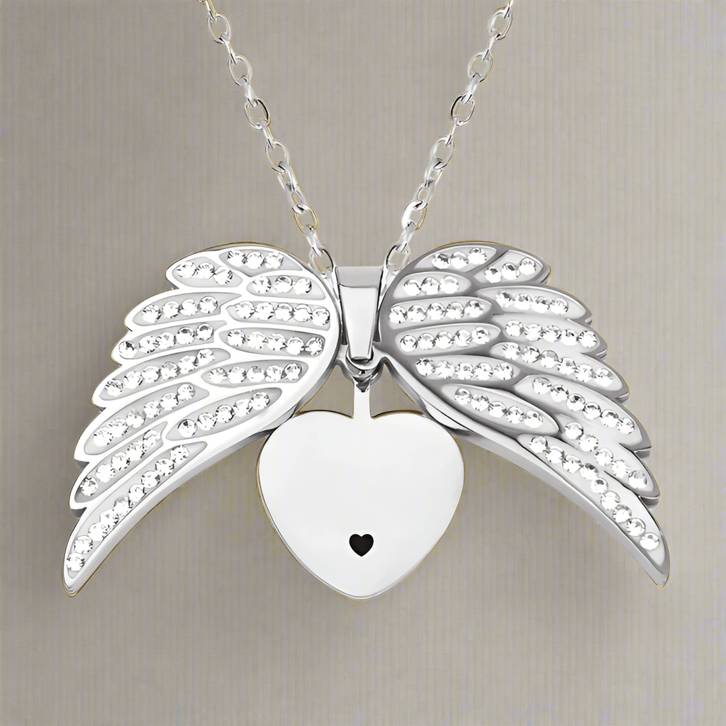 Silver heart pendant with angel wings, symbolizing love and protection, on chain by ORLA.