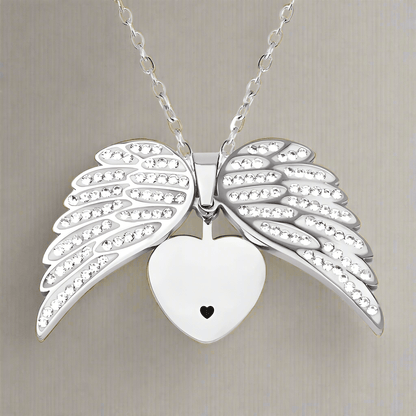 Silver heart pendant with angel wings, symbolizing love and protection, on chain by ORLA.