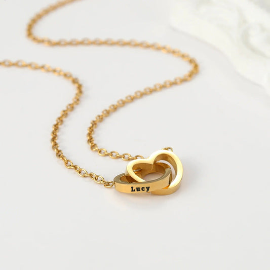 Orla Double Heart Necklace with two engraved heart charms intertwined on a gold chain